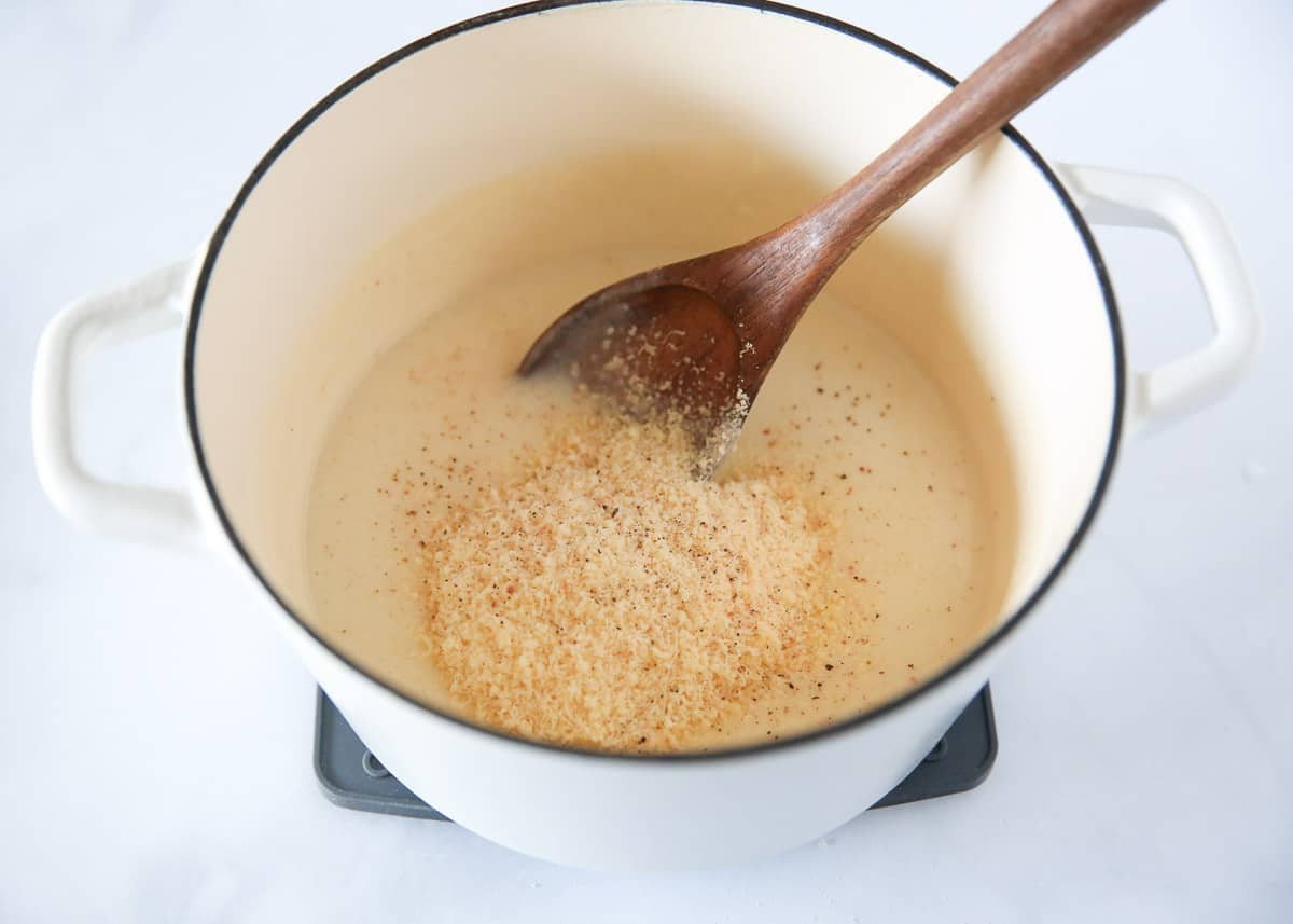 Cooking white sauce pasta.