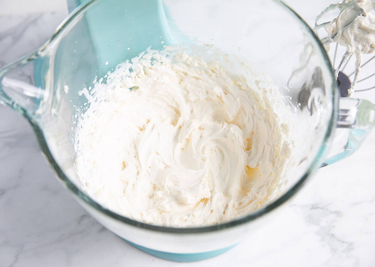 Cheesecake mixed together in a glass mixing bowl. 