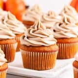 Pumpkin cupcake on a cake stand.