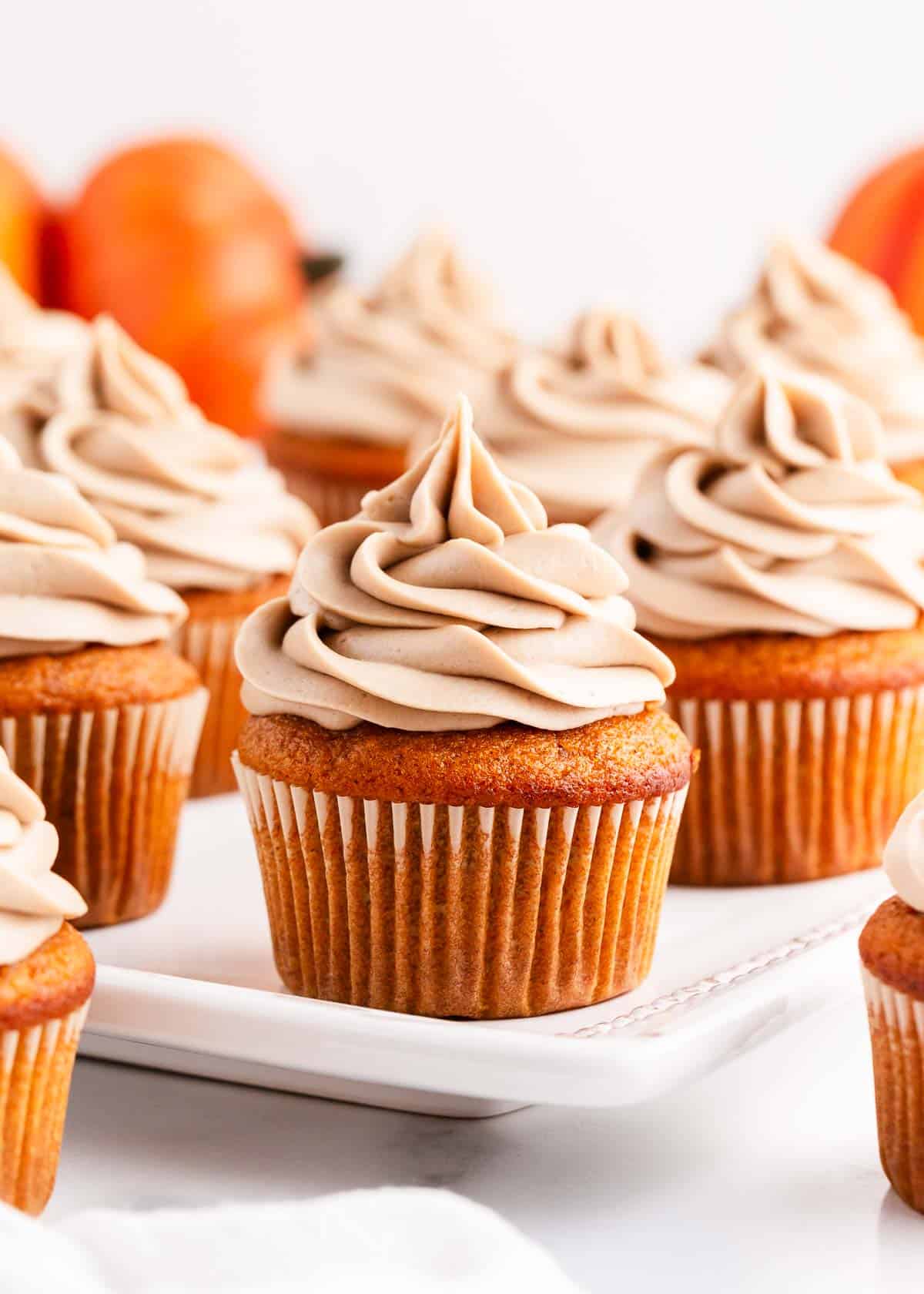 Pumpkin cupcake on a cake stand.