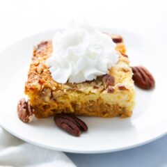 Slice of pumpkin dump cake on a white plate.