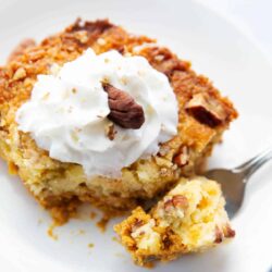 Slice of pumpkin dump cake on a plate.