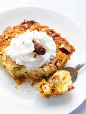Slice of pumpkin dump cake on a plate.