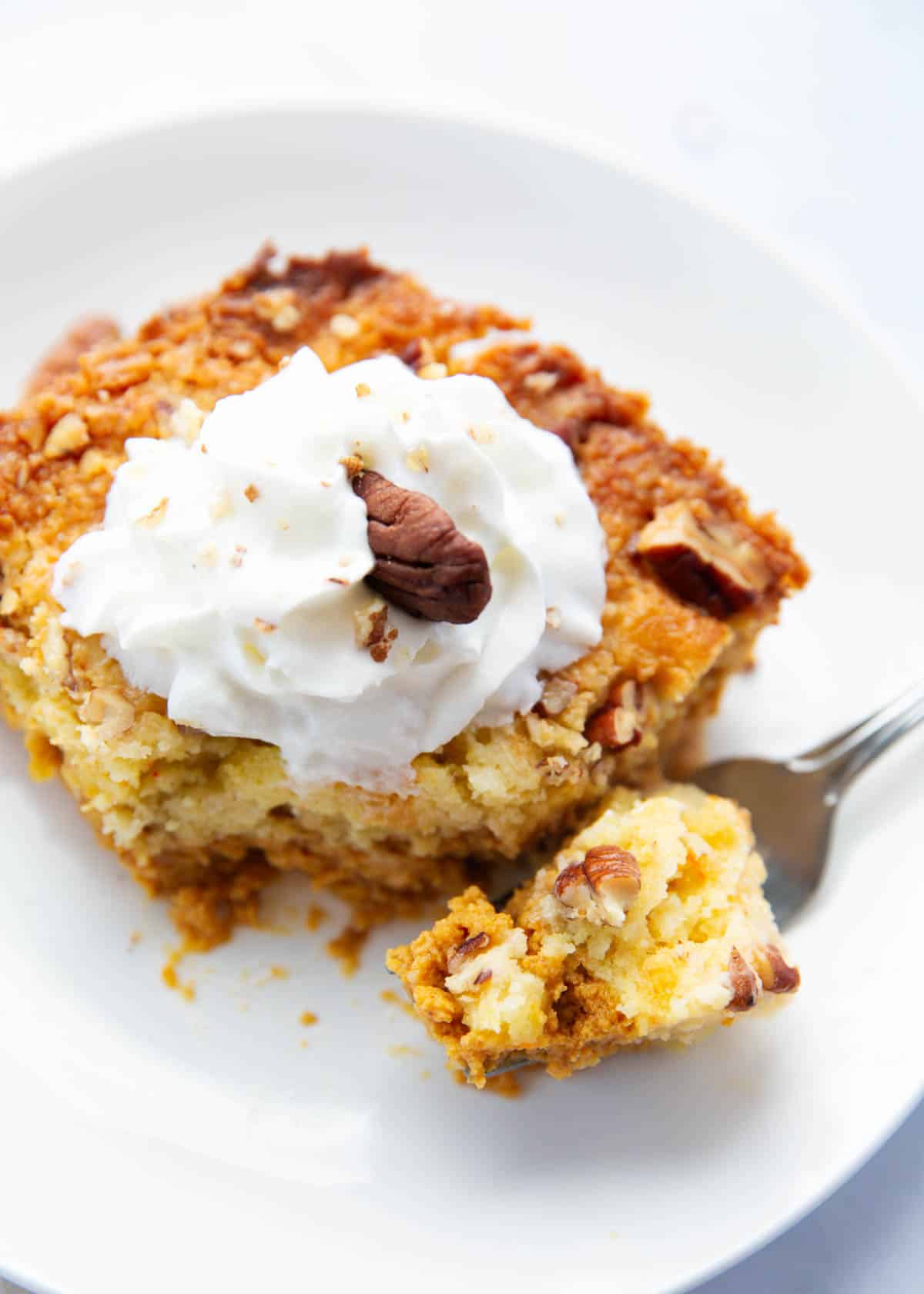 Slice of pumpkin dump cake on a plate.