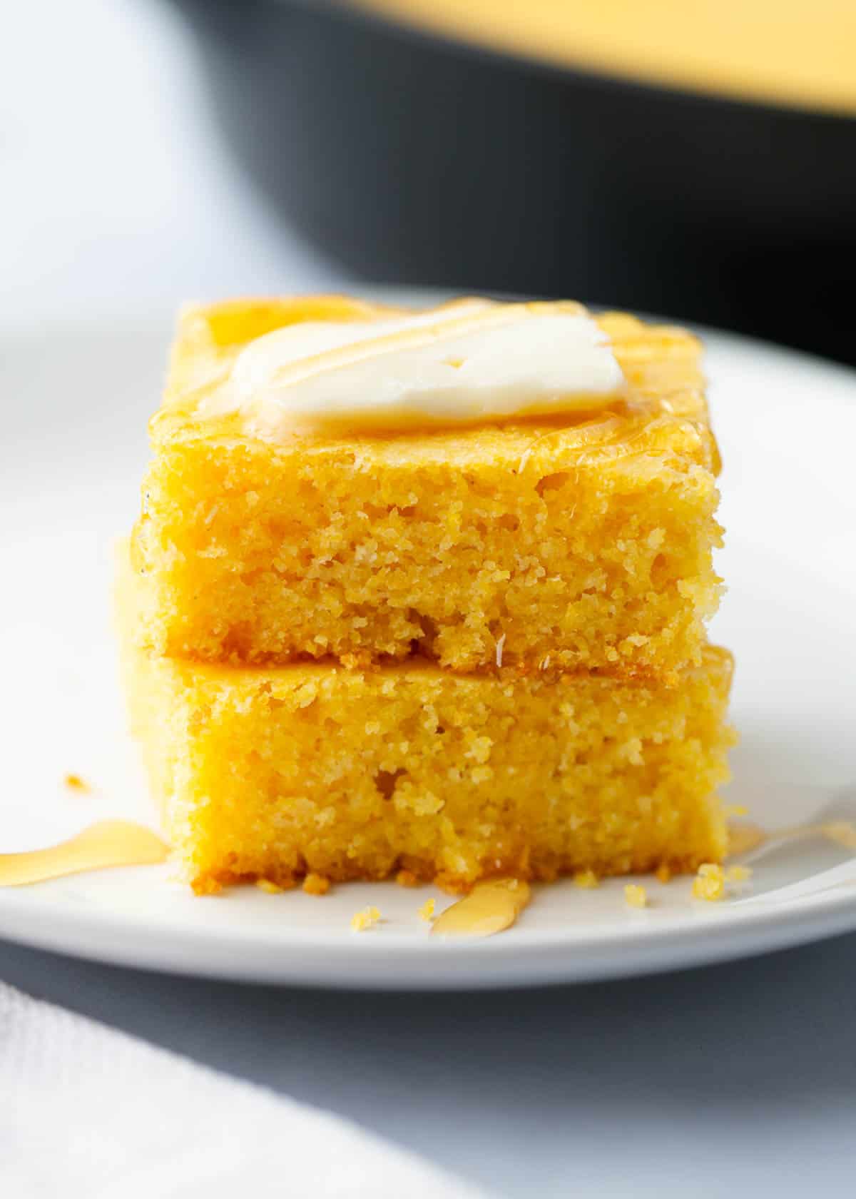 Stacked cornbread on a plate.