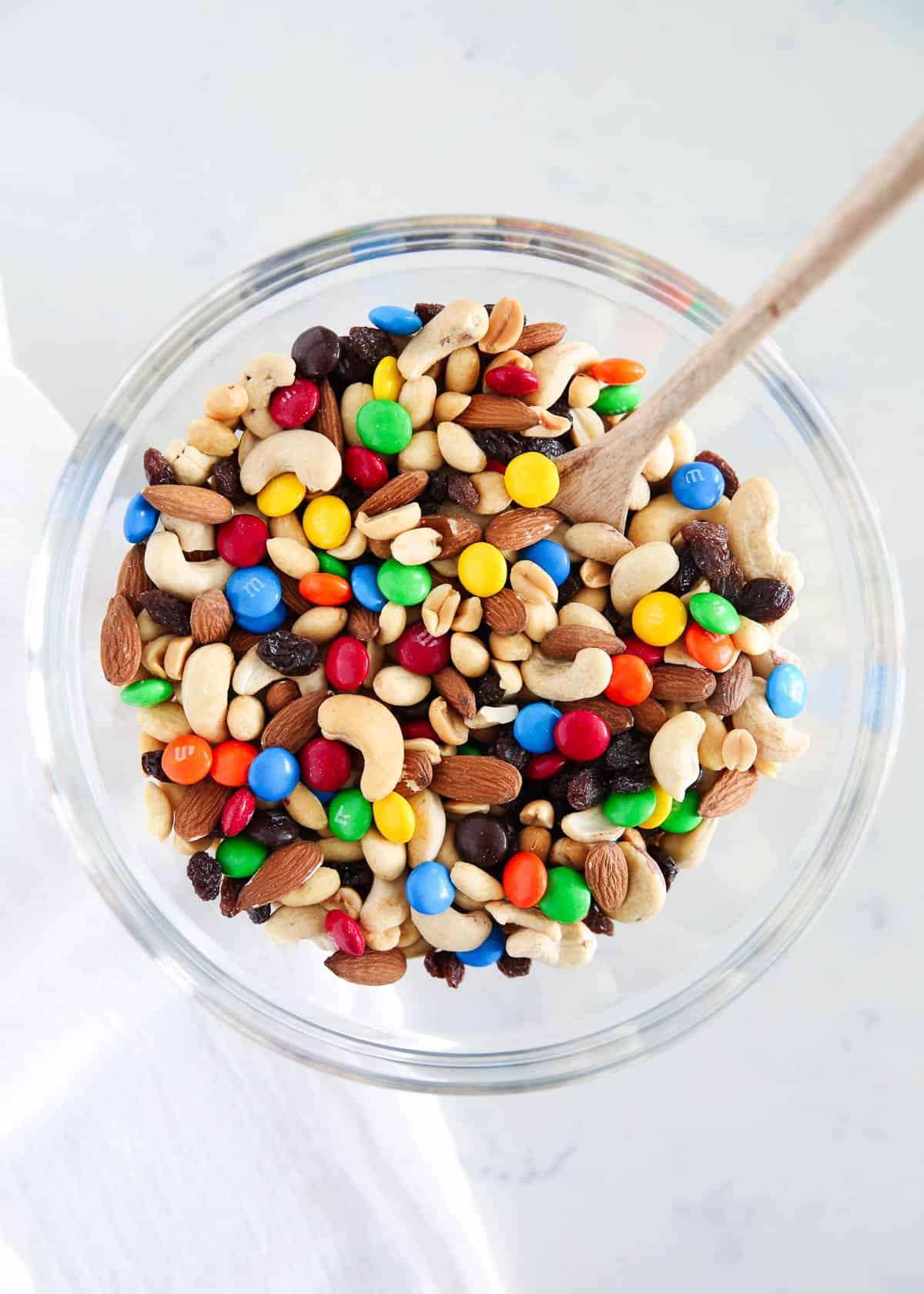 Up close photo of trail mix in a glass bowl. 