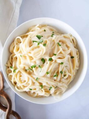 White sauce pasta in a white bowl.