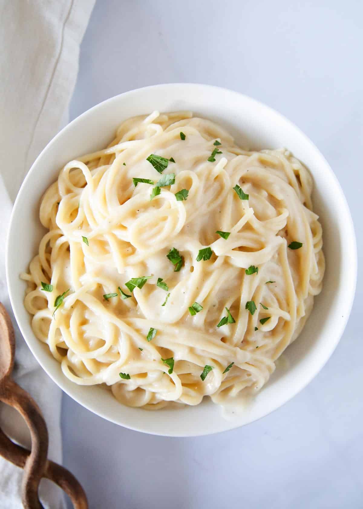 White sauce pasta in a white bowl.