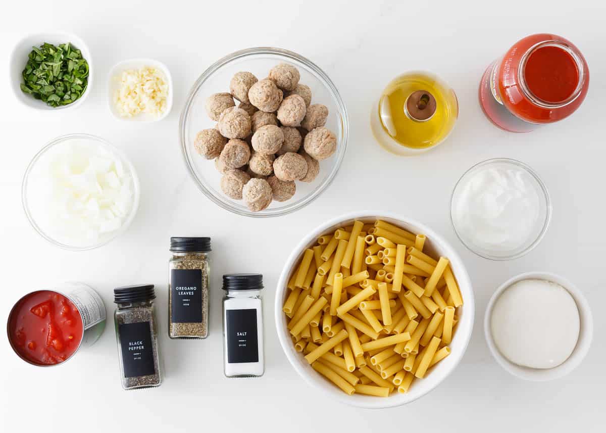 Baked ziti with meatballs ingredients on counter.