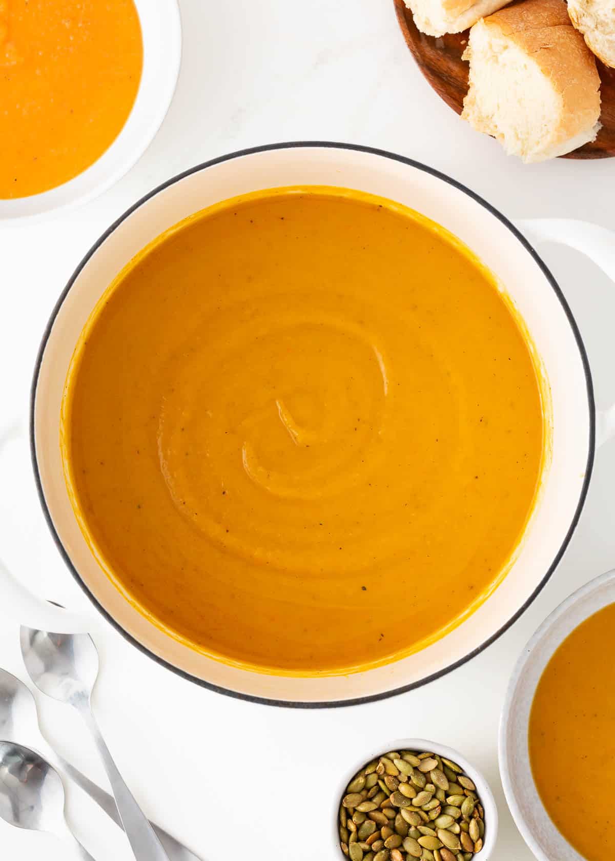 Butternut squash soup in a white pot.