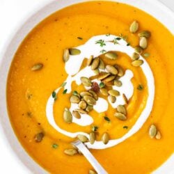 Butternut squash soup in a bowl with a spoon.