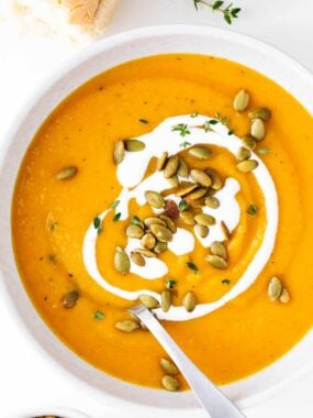Butternut squash soup in a bowl with a spoon.