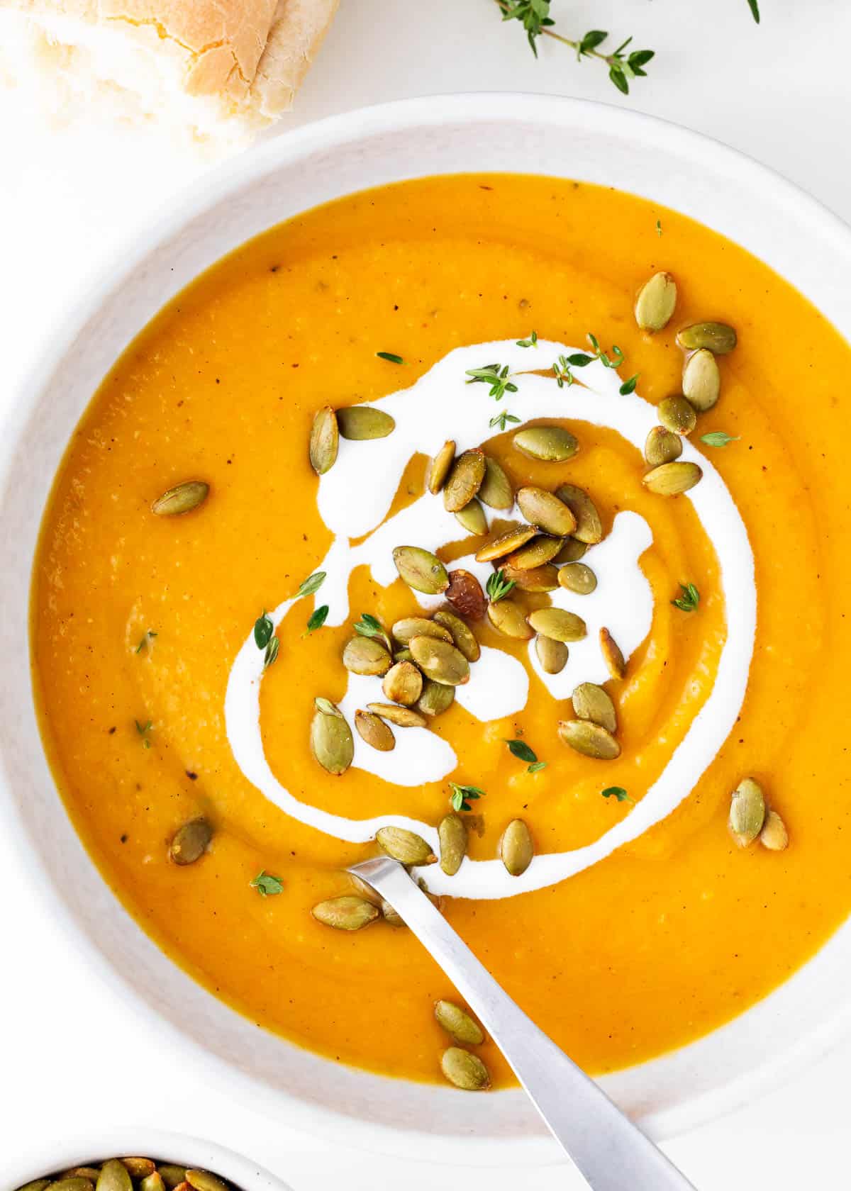 Butternut squash soup in a bowl with a spoon.