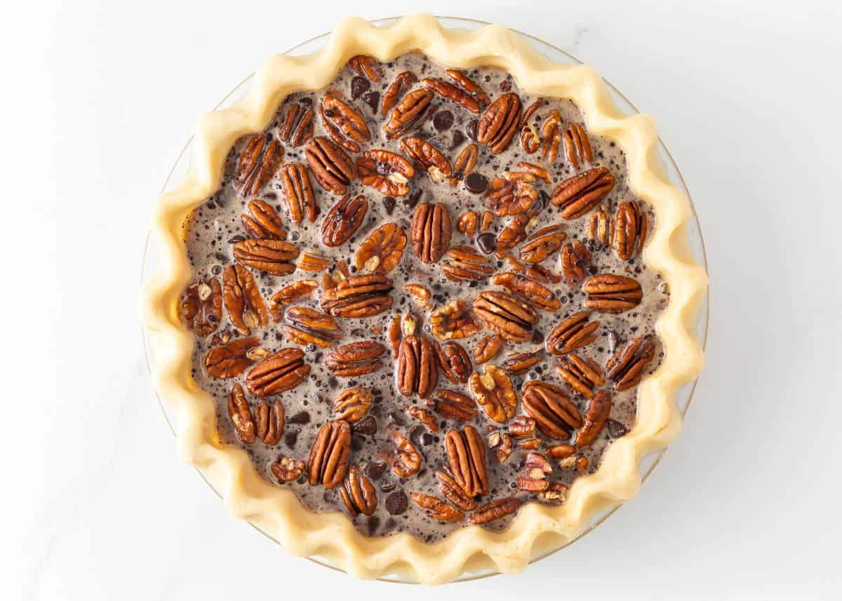 Showing how to make chocolate pecan pie. 