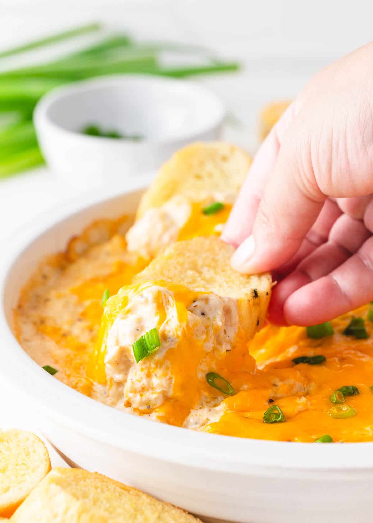 Dipping bread into crab dip.