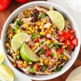 Crockpot Mexican chicken in a white bowl.