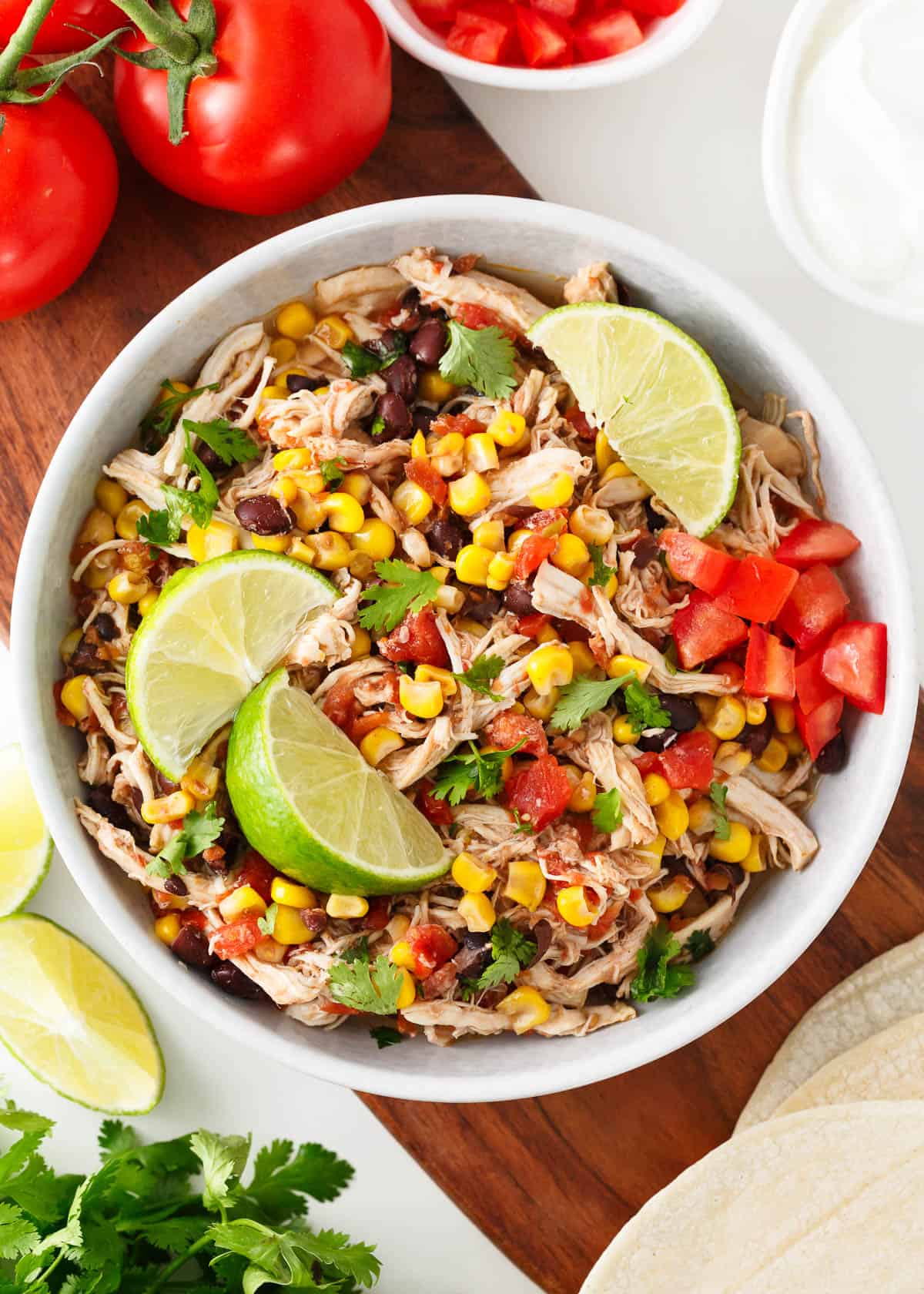 Crockpot Mexican chicken in a white bowl.