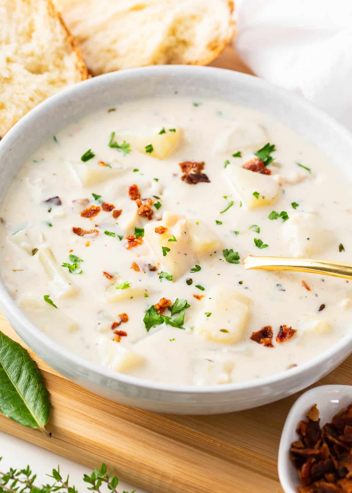 Clam chowder in a bowl with a spoon. 