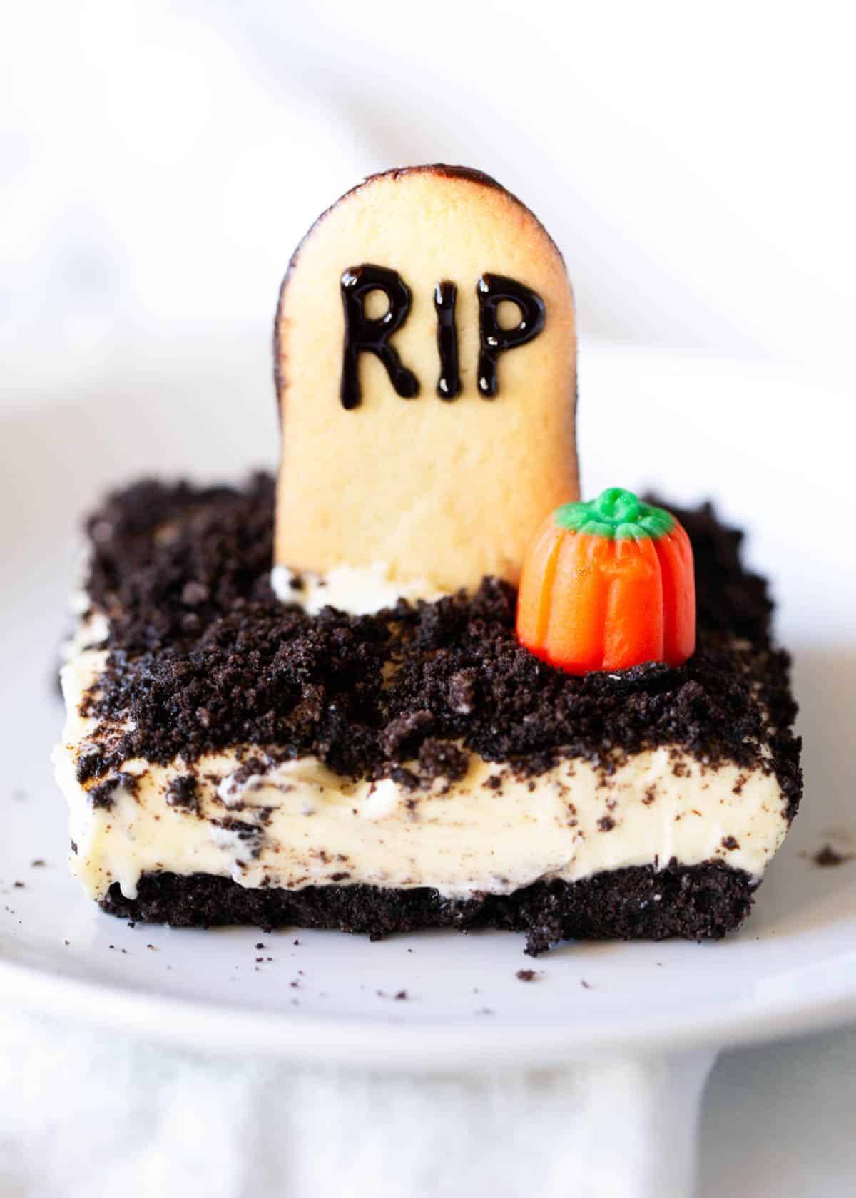 Halloween oreo dirt cake on a white plate.