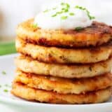 Stack of mashed potato pancakes on a plate.