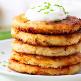 Stack of mashed potato pancakes on a plate.