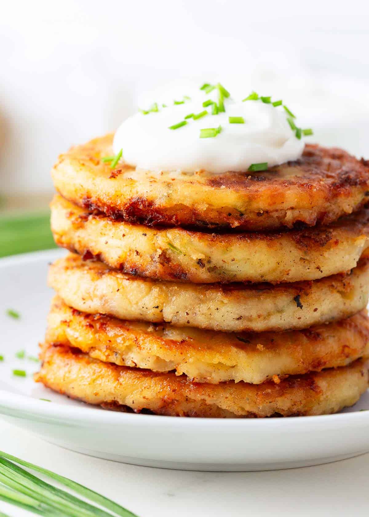 Stack of mashed potato pancakes on a plate. 