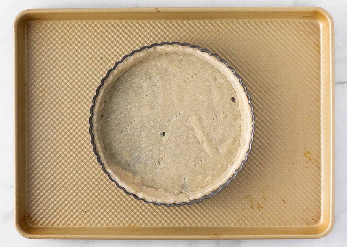 Unbaked pie crust on baking sheet.