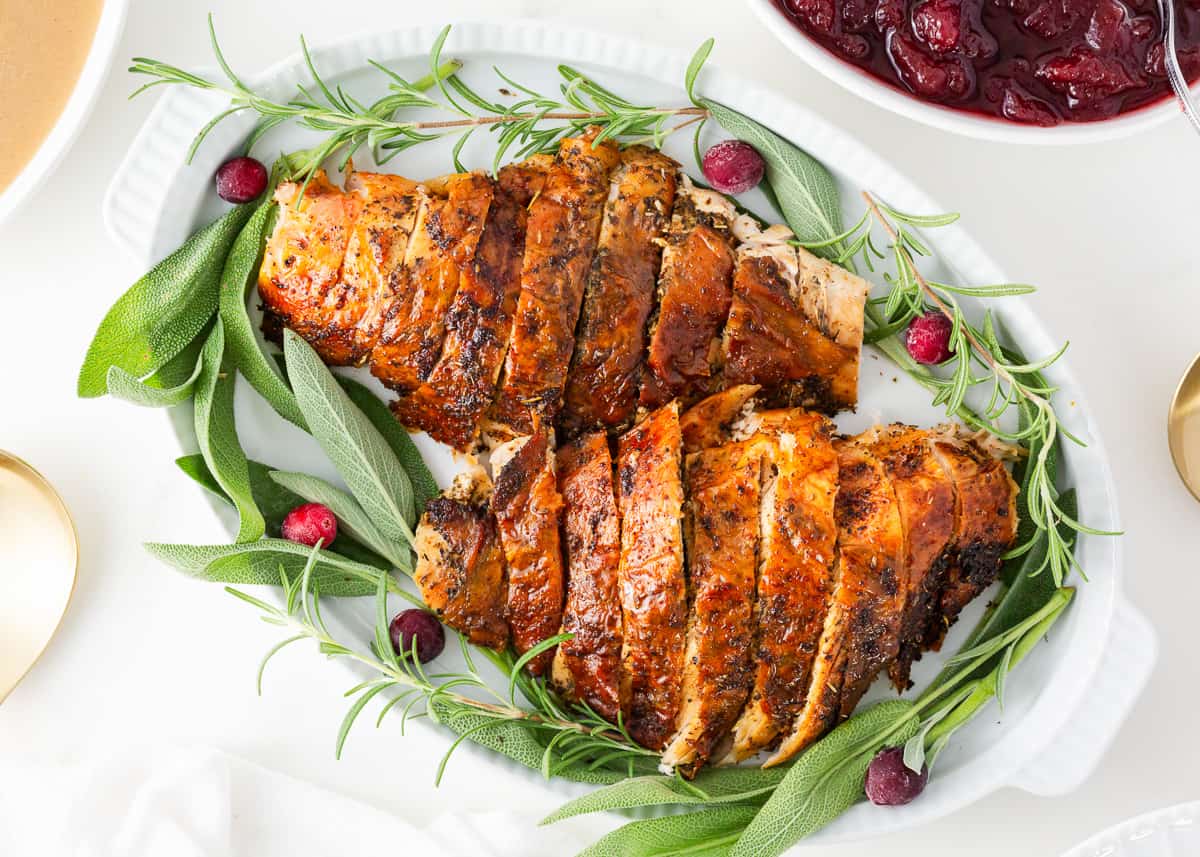 Discover the perfect oven roasted turkey breast recipe for any occasion! Whether you’re craving a juicy turkey feast or a quick family dinner, my step-by-step guide will show you how! Sliced turkey breast on a platter.