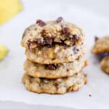 Stack of banana chocolate chip oatmeal cookies on counter.