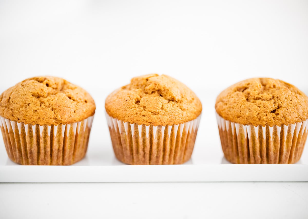 Pumpkin muffins on a white plate.