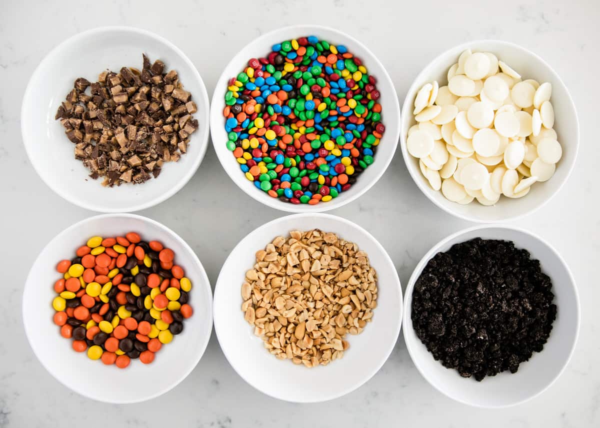 Caramel apple toppings on counter.