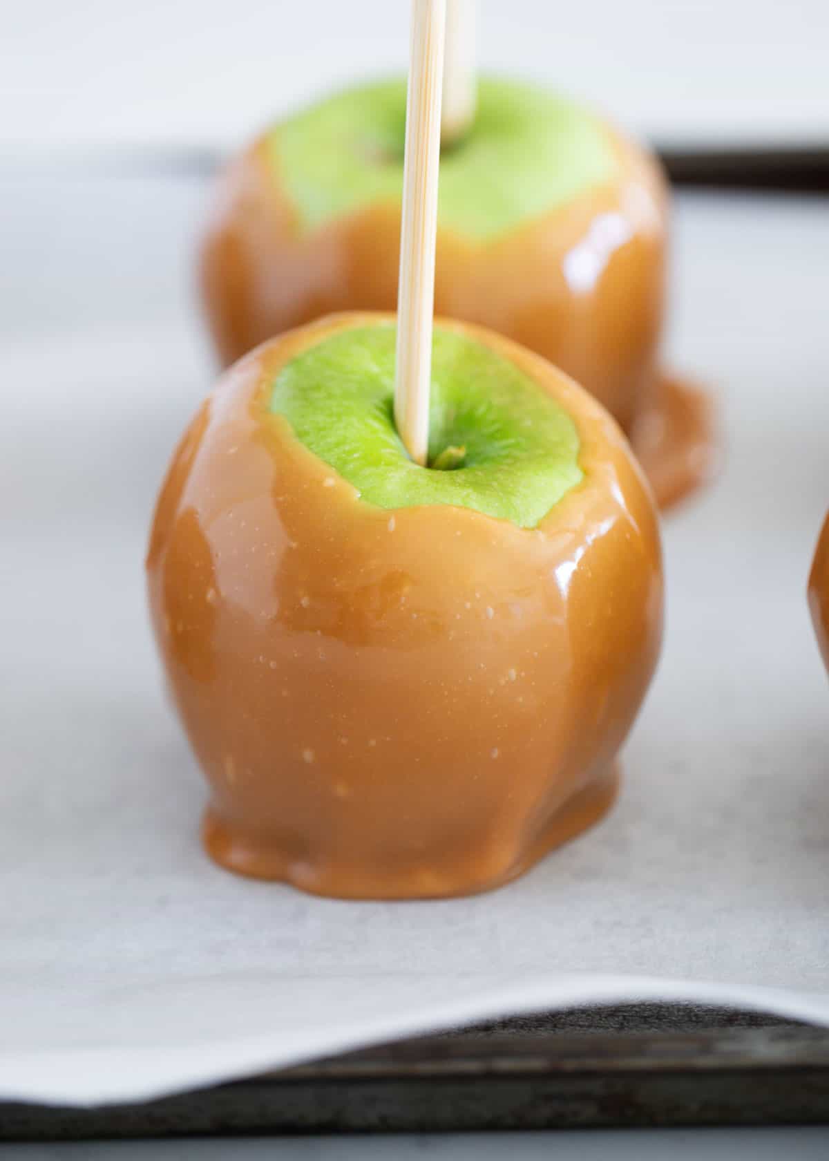 Caramel apple on baking sheet.