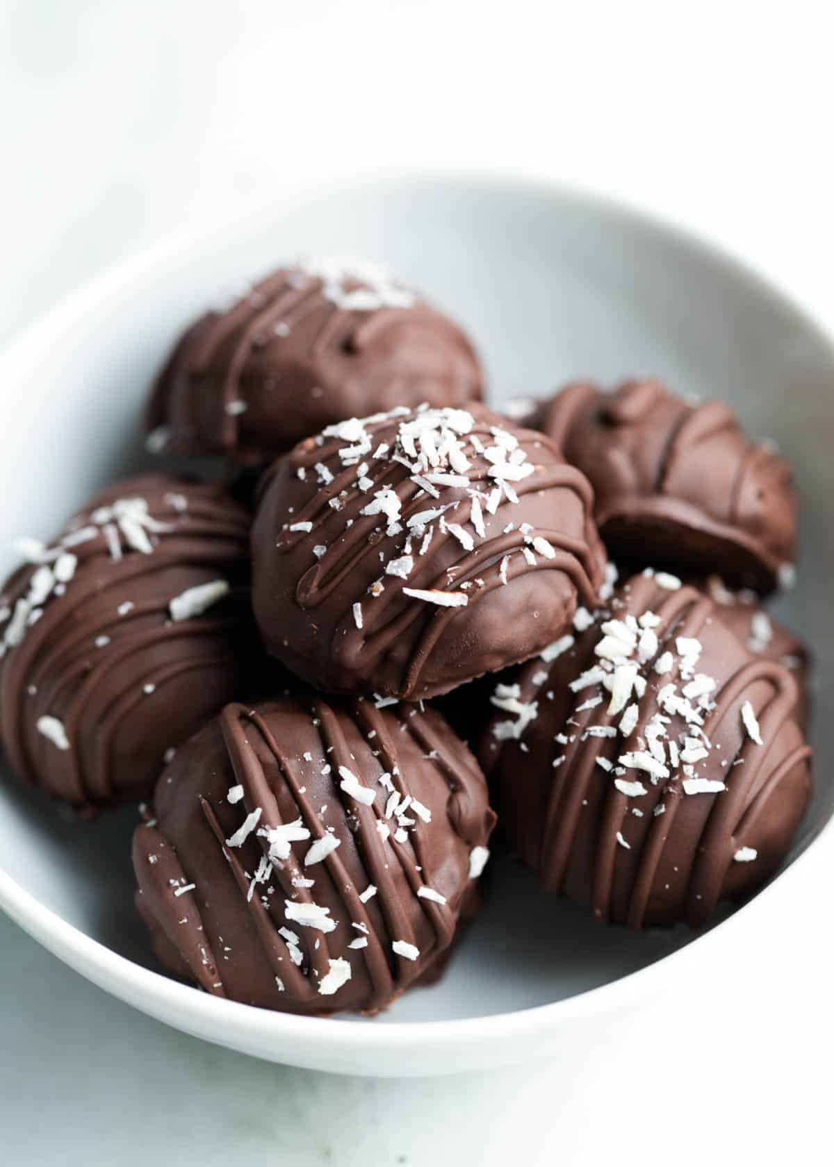 Chocolate coconut balls in a bowl.