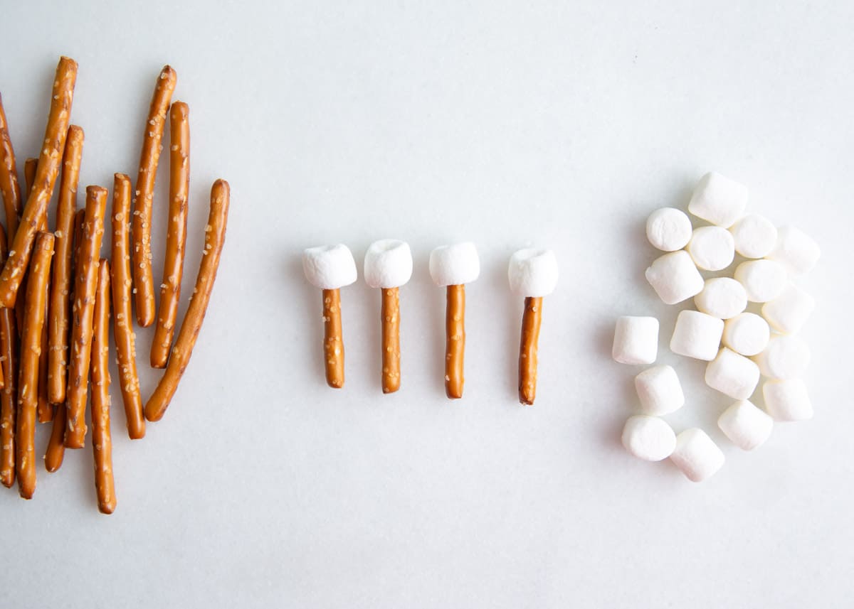 Marshmallows and pretzels on counter.