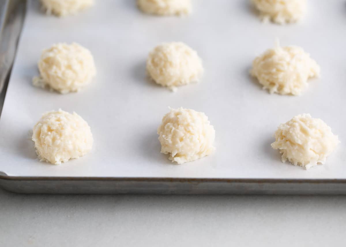 Coconut balls on a baking sheet.