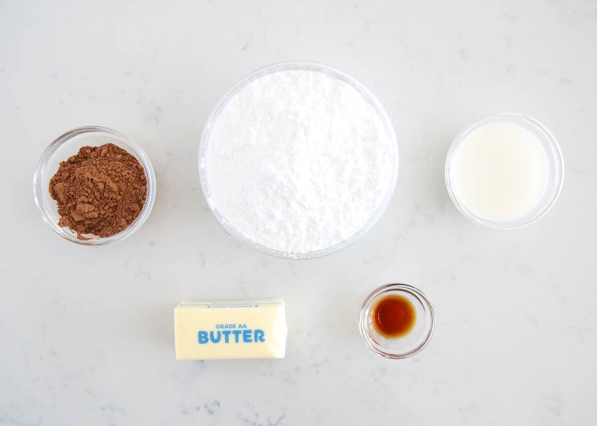 Chocolate icing ingredients on counter.