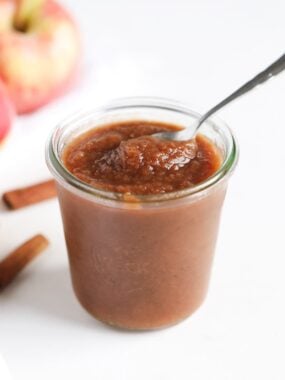 Apple butter in a jar with spoon.