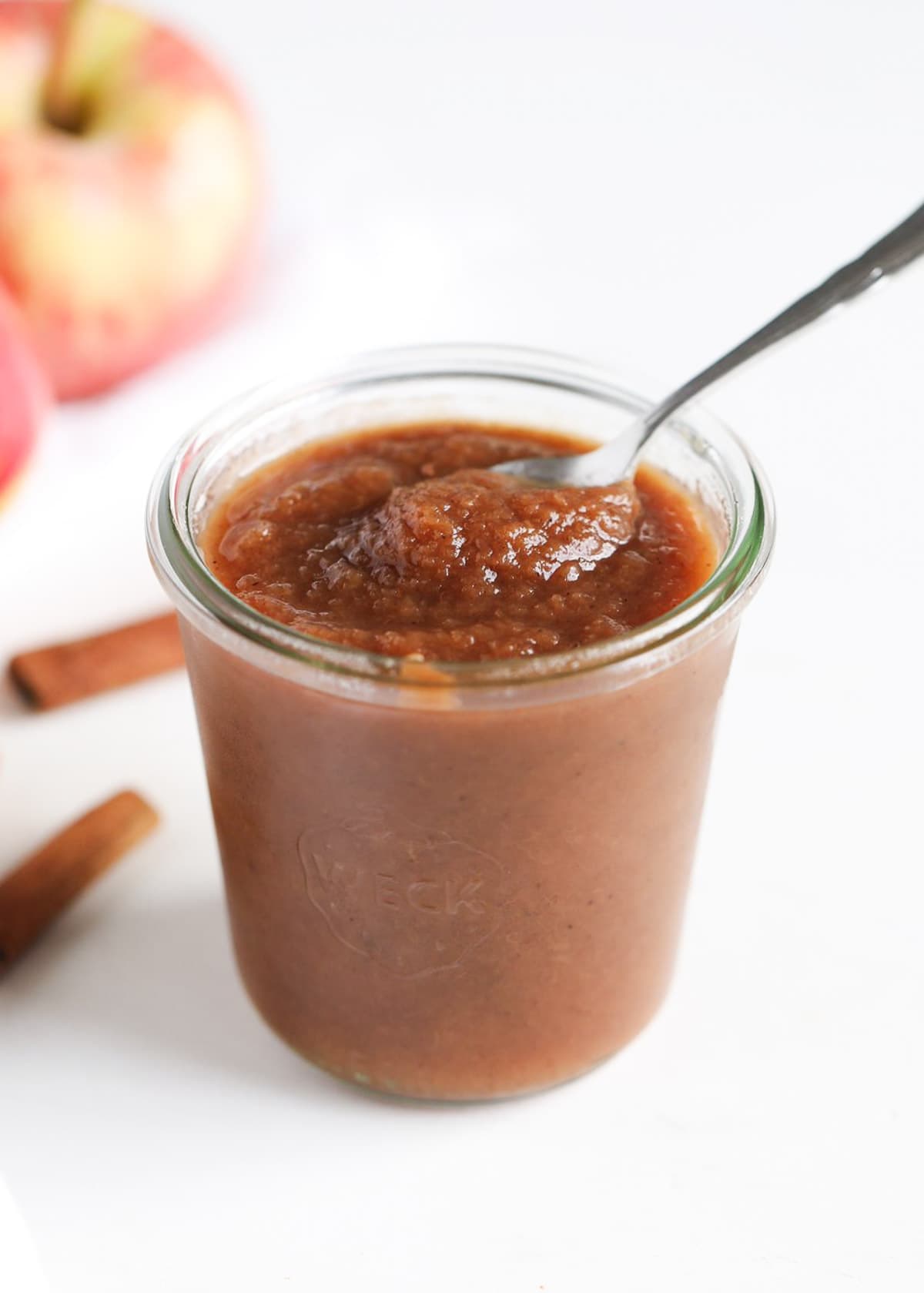 Apple butter in a jar with spoon.