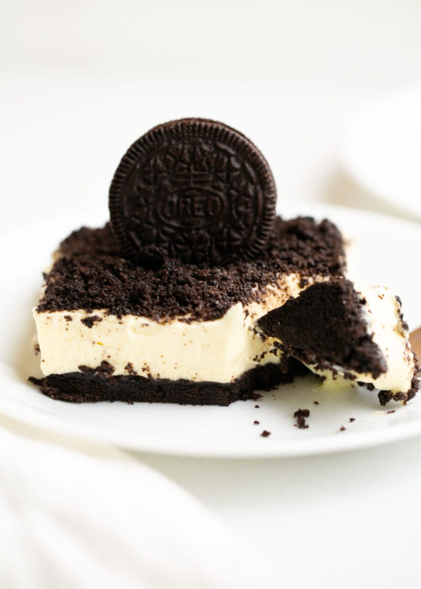 Slice of oreo dirt cake on a plate.