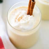 Eggnog in a cup with whipped cream.