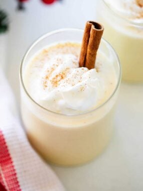 Eggnog in a cup with whipped cream.
