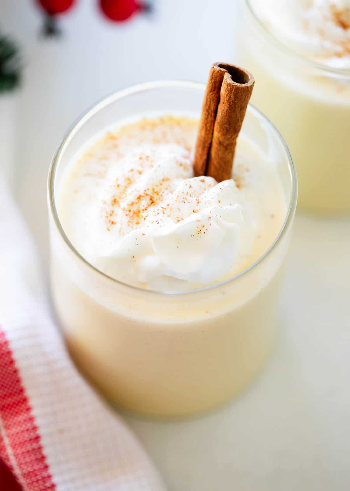 Eggnog in a cup with whipped cream.