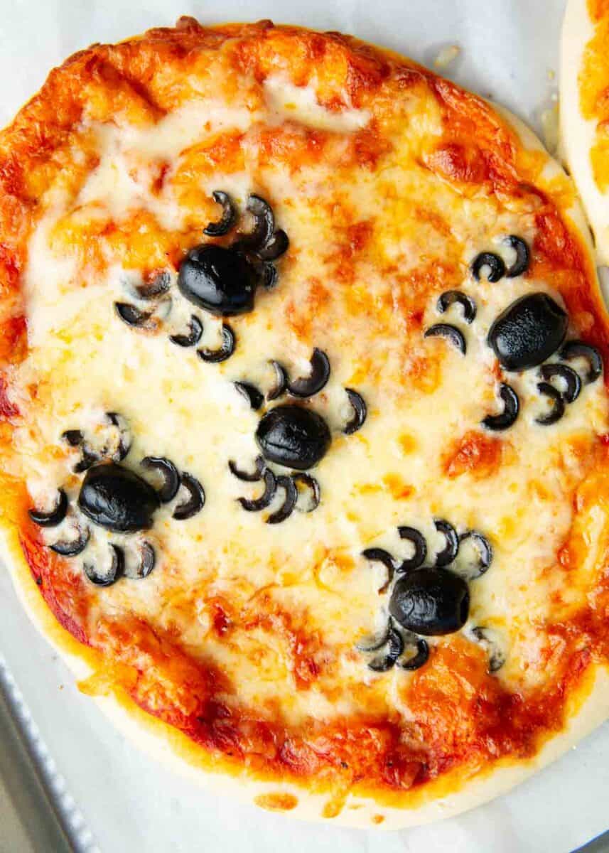 Spider Halloween pizza on a baking sheet.