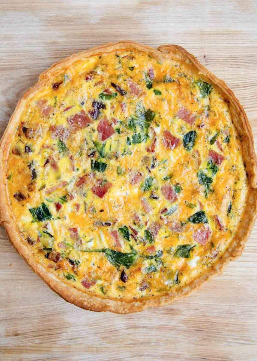 Quiche on a wooden board.