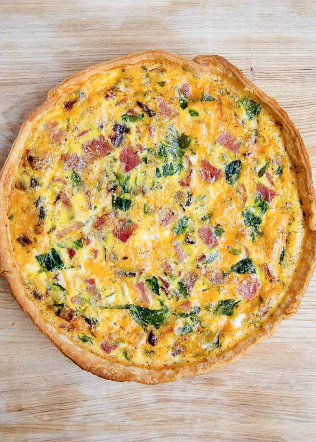 The best quiche recipe on a wooden board.