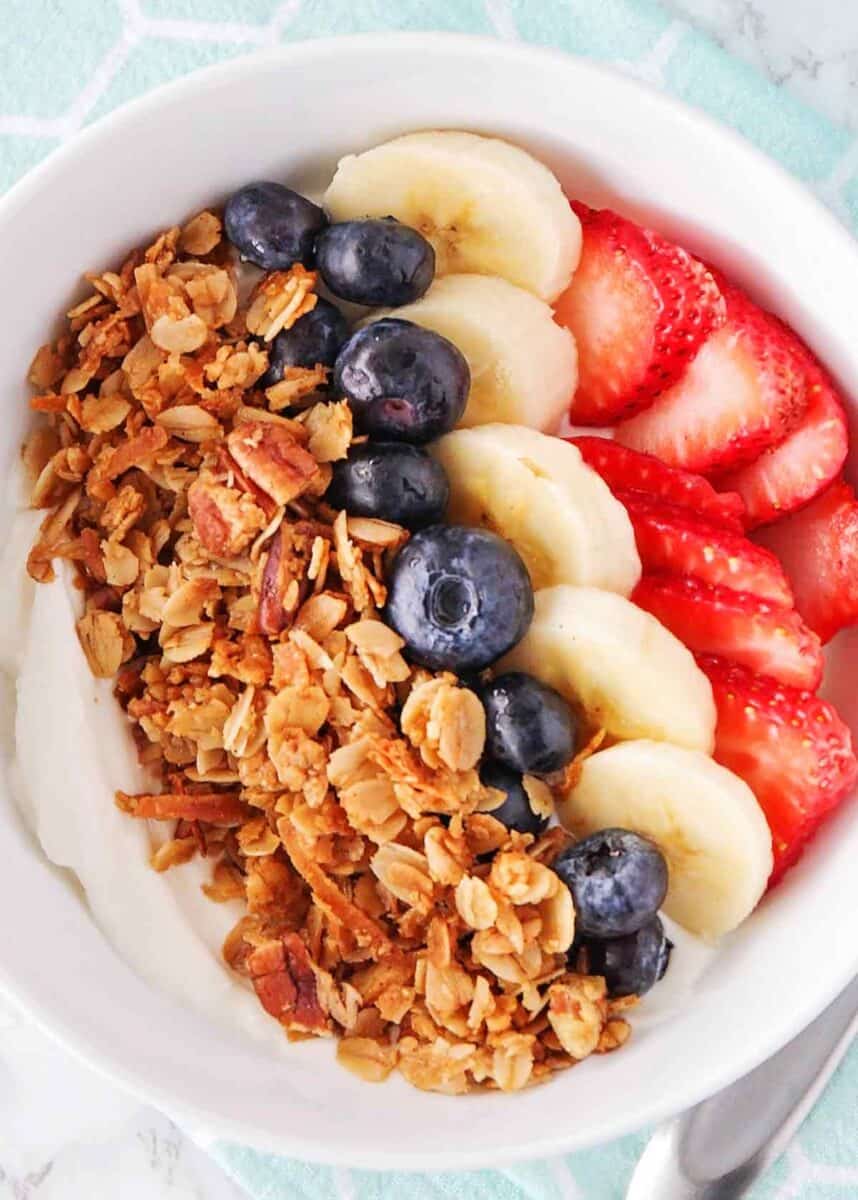 Granola ina bowl with fruit and yogurt.