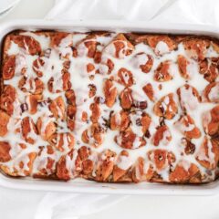 Cinnamon roll casserole made with ready made dough topped with frosting.