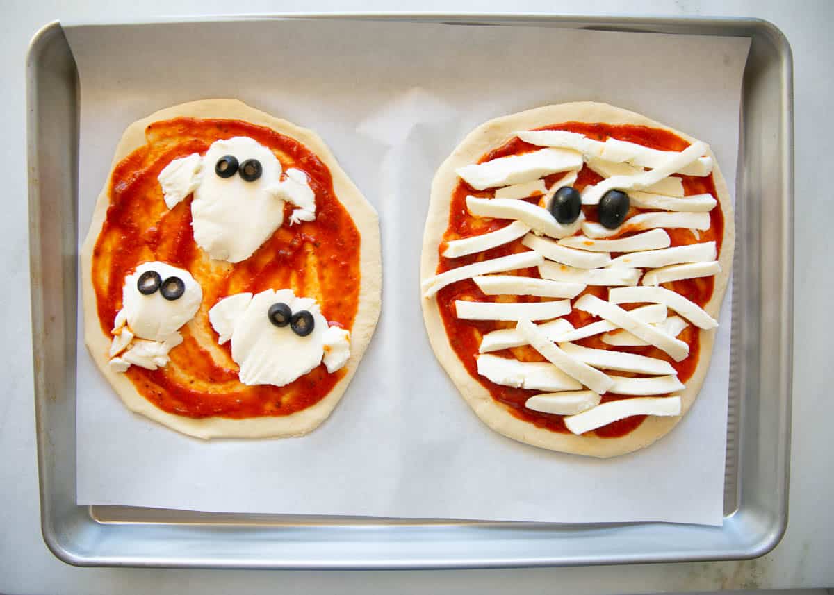 Showing how to make Halloween pizza on a baking sheet.