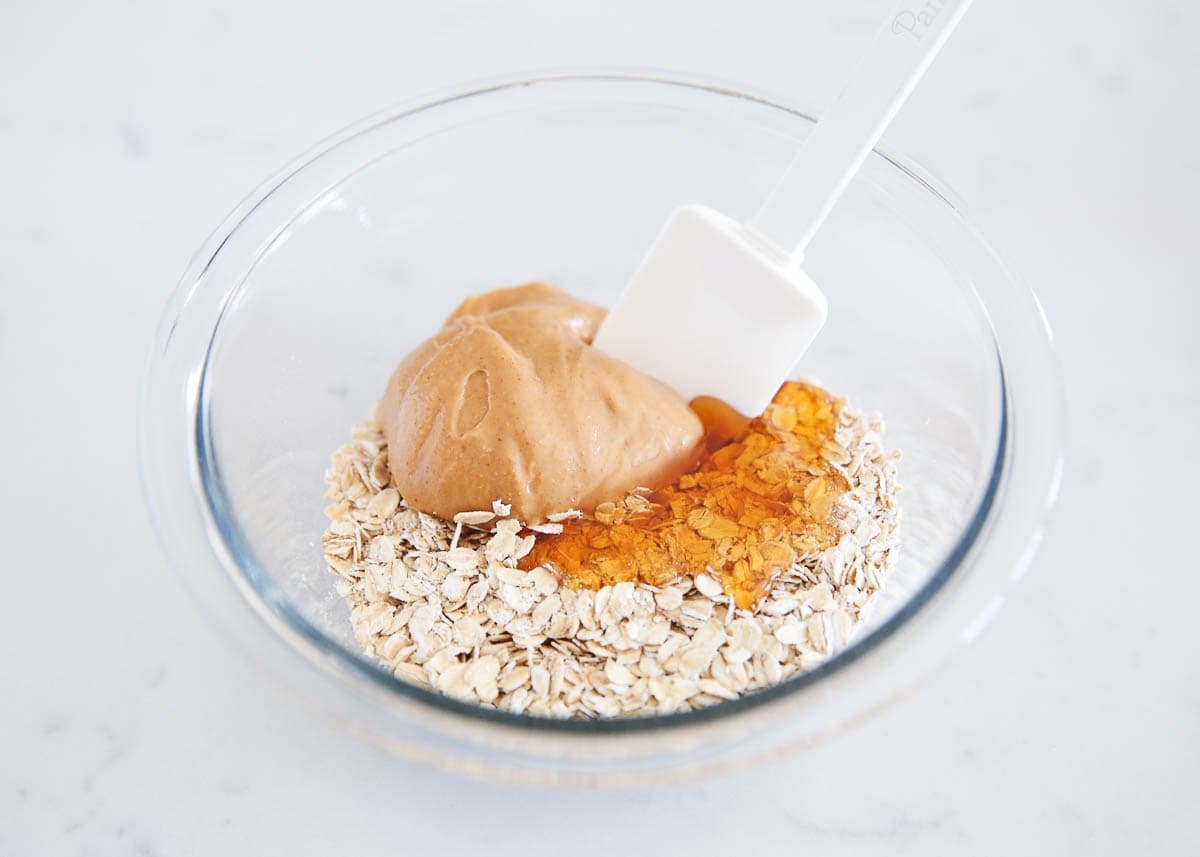 Ingredients in a glass bowl with a white spatula. 