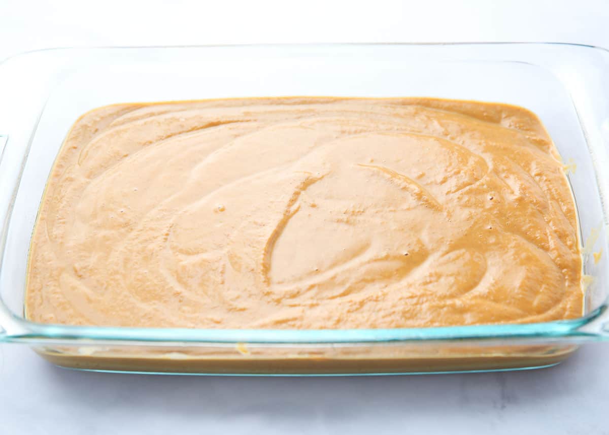 Pumpkin cake batter in a glass dish. 